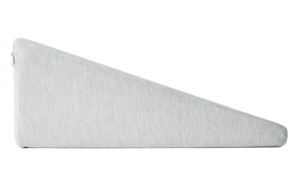 Beige wedge pillow on a bed with a wooden headboard